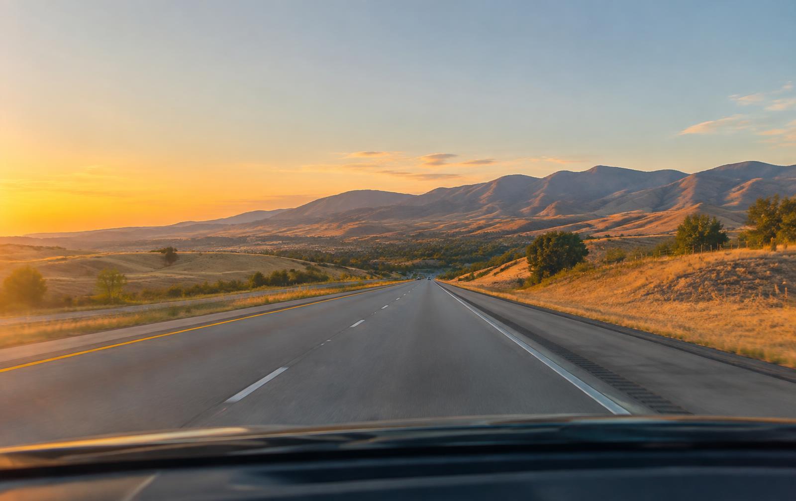 Open Treasure Valley highway at sunset seen through a clean windshield