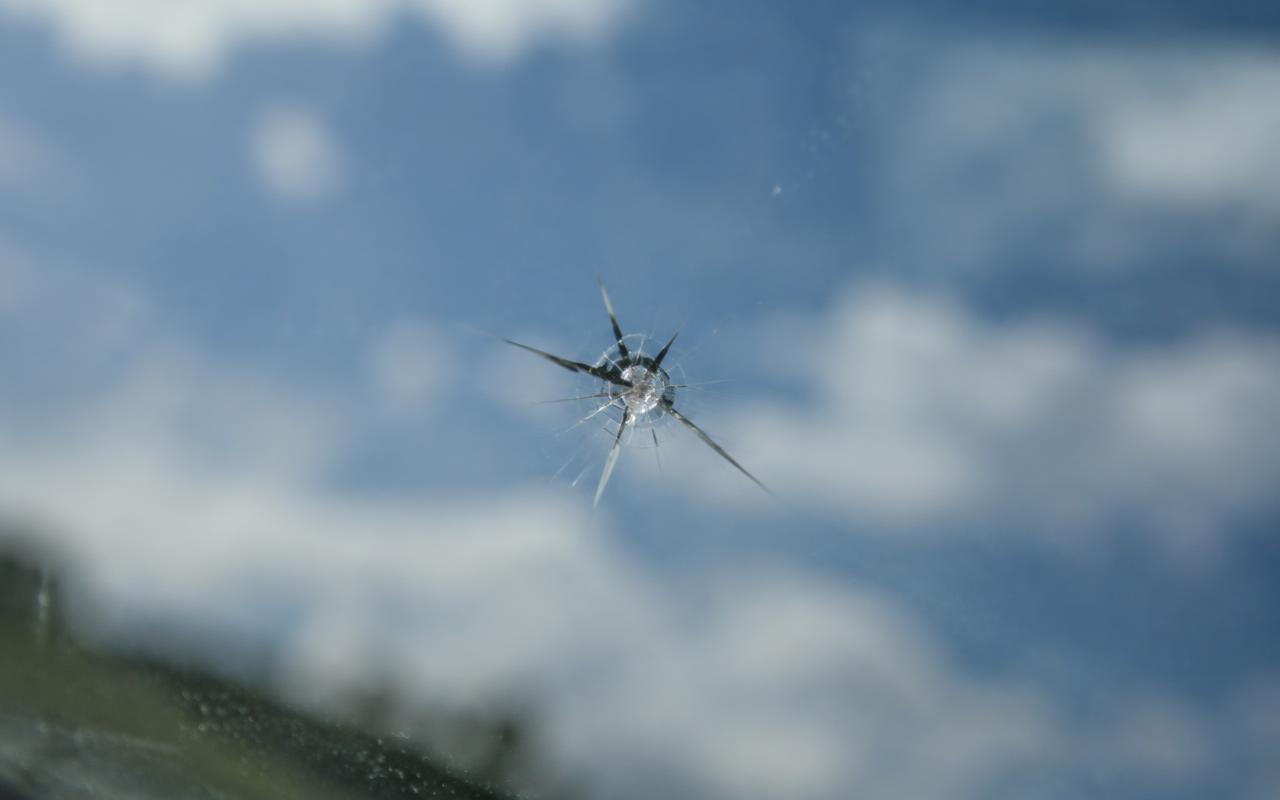 Close-up of a small rock chip in a windshield